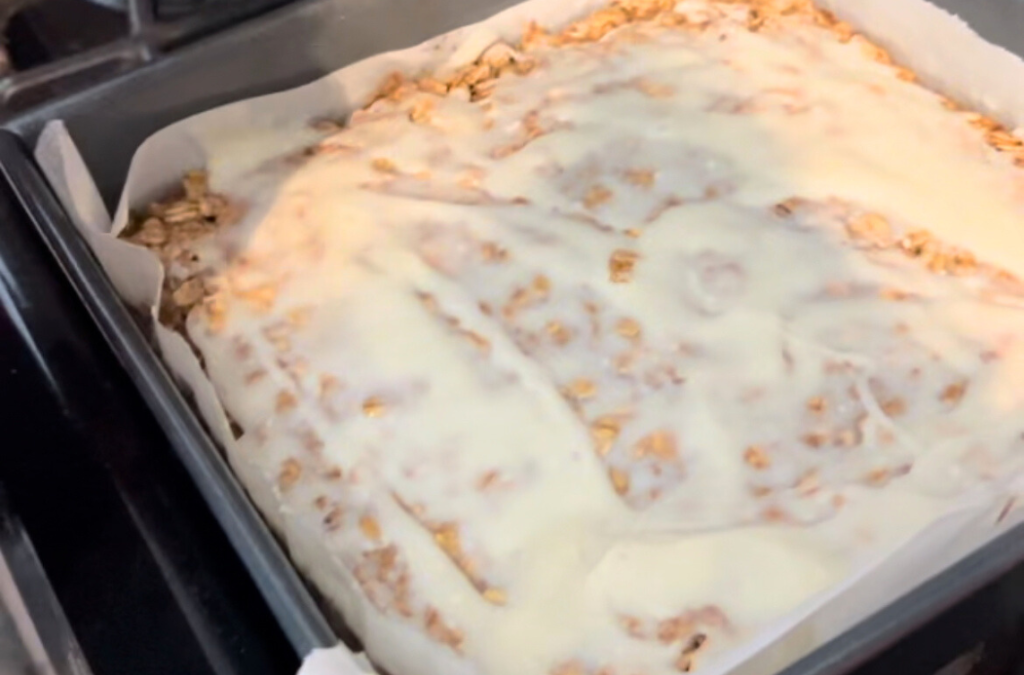 iced oatmeal cinnamon roll bake in pan