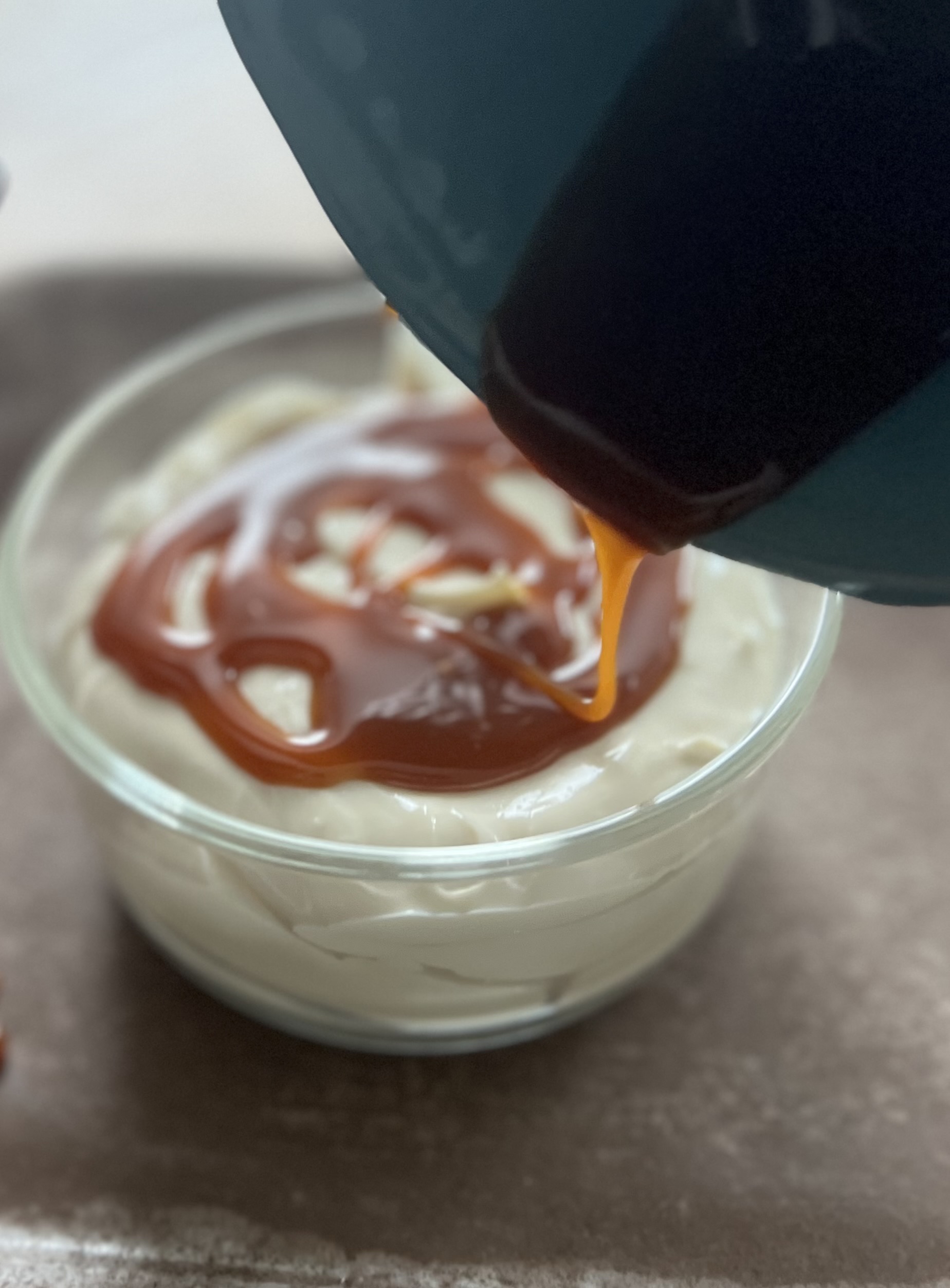 creamy greek yogurt dip with caramel being drizzled on top