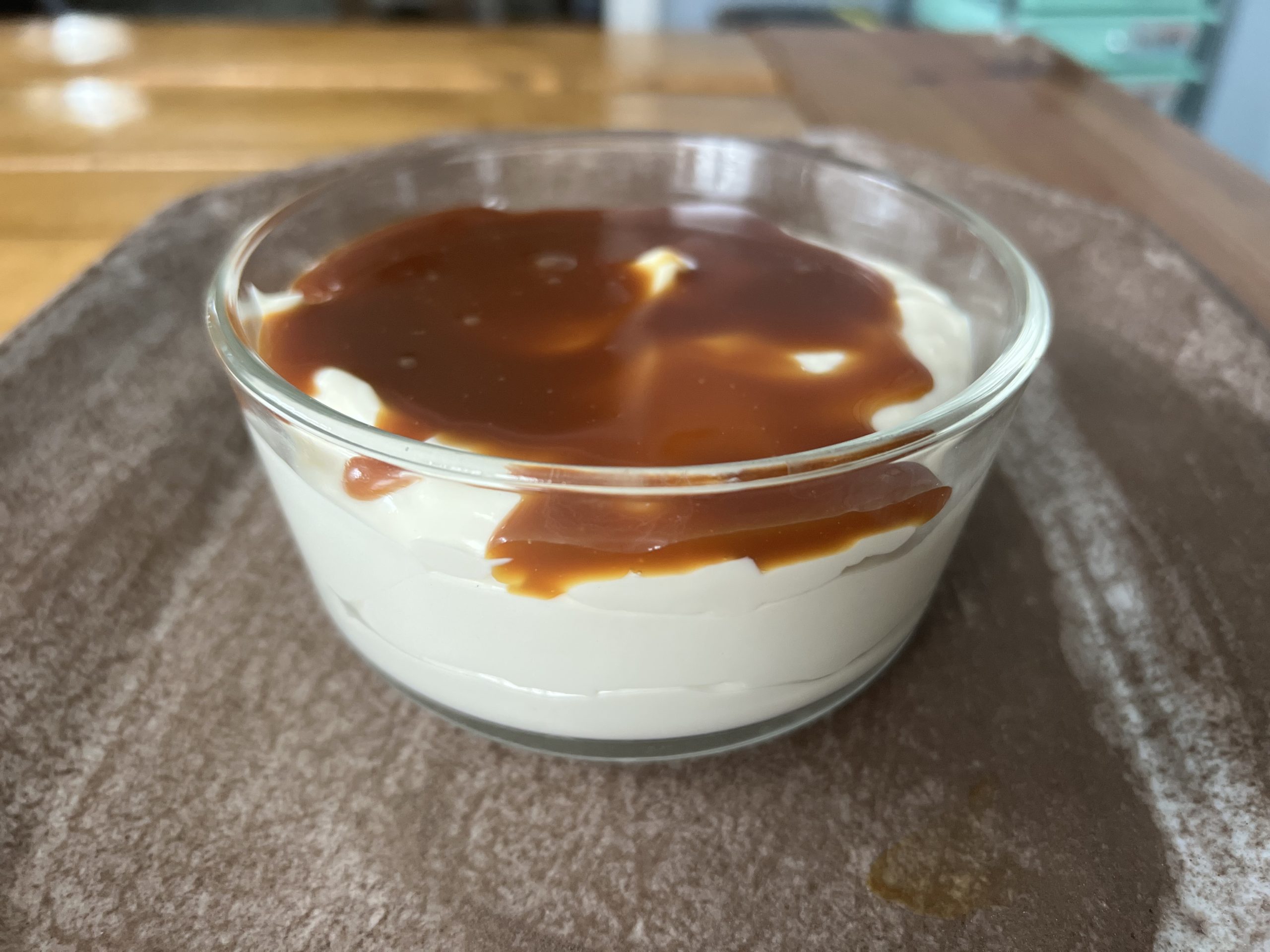 creamy greek yogurt dip with caramel on a brown ceramic plate